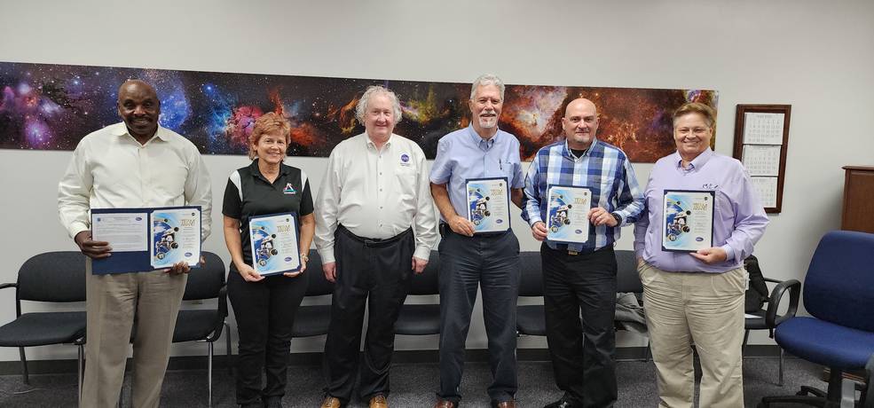 William Hill, third from left, safety and mission assurance director at NASAs Marshall Space Flight Center, presents a Space Flight Awareness team award June 20 at the agencys Kennedy Space Center.