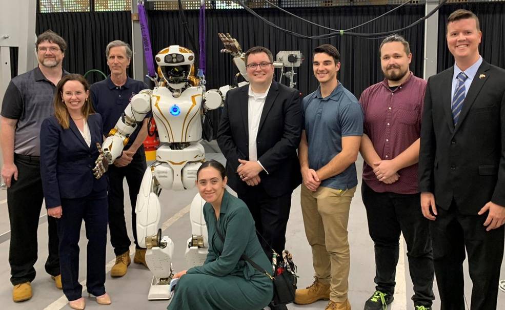 NASAs Dexterous Robotics Team and U.S. State Department representatives with NASAs Valkyrie robot at Woodside Energy.