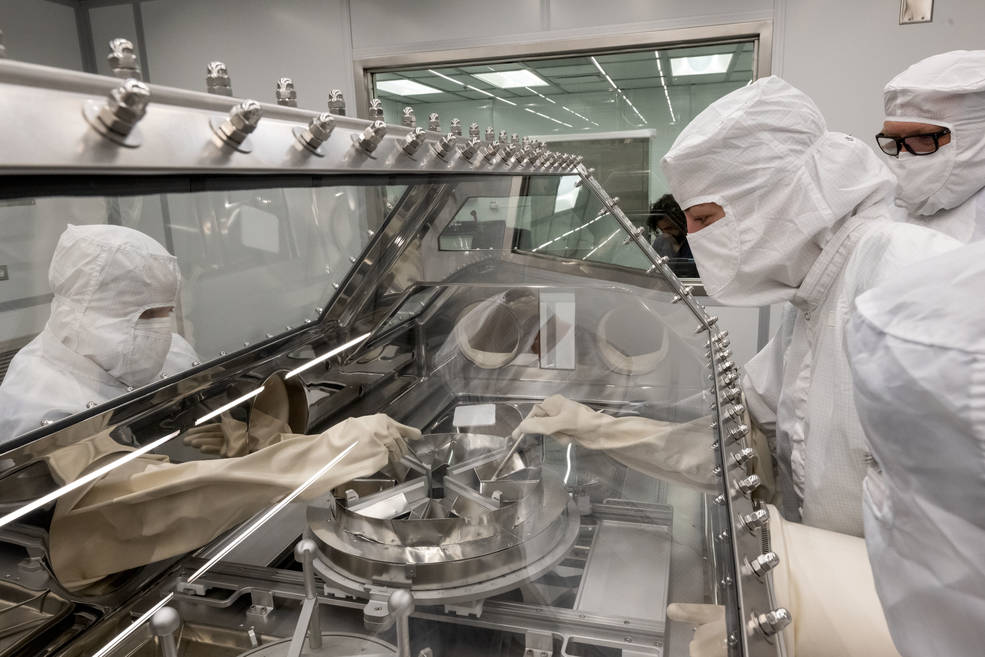 NASAs OSIRIS-REx curation team rehearse the opening of the asteroid sample canister in the newly built OSIRIS-REx Curation lab at Johnson Space Center.