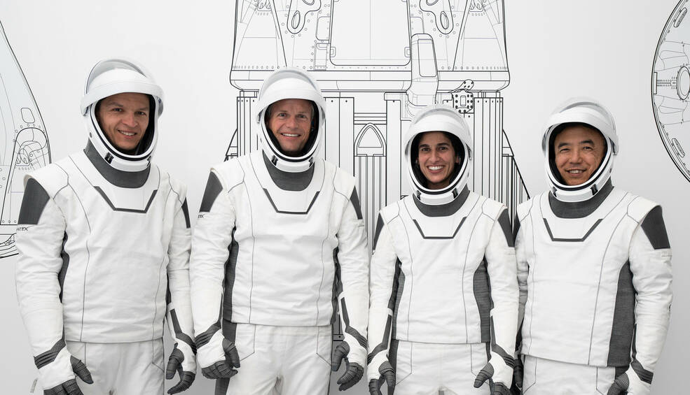 The four crew members who comprise NASAs SpaceX Crew-7 mission pose for a photo in their spacesuits.