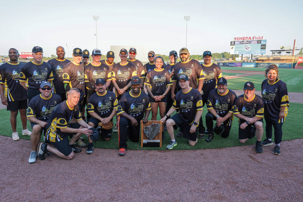 Team Redstone, which includes various representatives from tenant organizations on Redstone Arsenal, pose with their plaque after defeating the North Alabama Rockets.