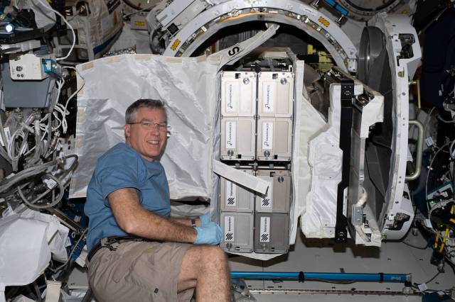 NASA astronaut and Expedition 69 Flight Engineer Stephen Bowen installs the NanoRacks CubeSat Deployer into the Kibo laboratory module's airlock.