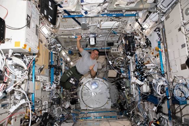 NASA astronaut and Expedition 69 Flight Engineer Frank Rubio is pictured setting up robotic camera hardware inside the International Space Station's Kibo laboratory module.
