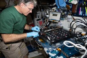 NASA astronaut and Expedition 69 Flight Engineer Stephen Bowen works on the Plant Habitat-03B Science Carrier, a space botany research device, in the International Space Station's Harmony module.
