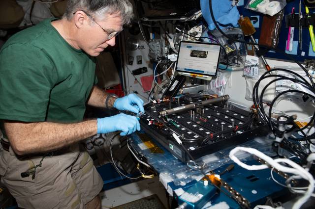 NASA astronaut and Expedition 69 Flight Engineer Stephen Bowen works on the Plant Habitat-03B Science Carrier, a space botany research device, in the International Space Station's Harmony module.