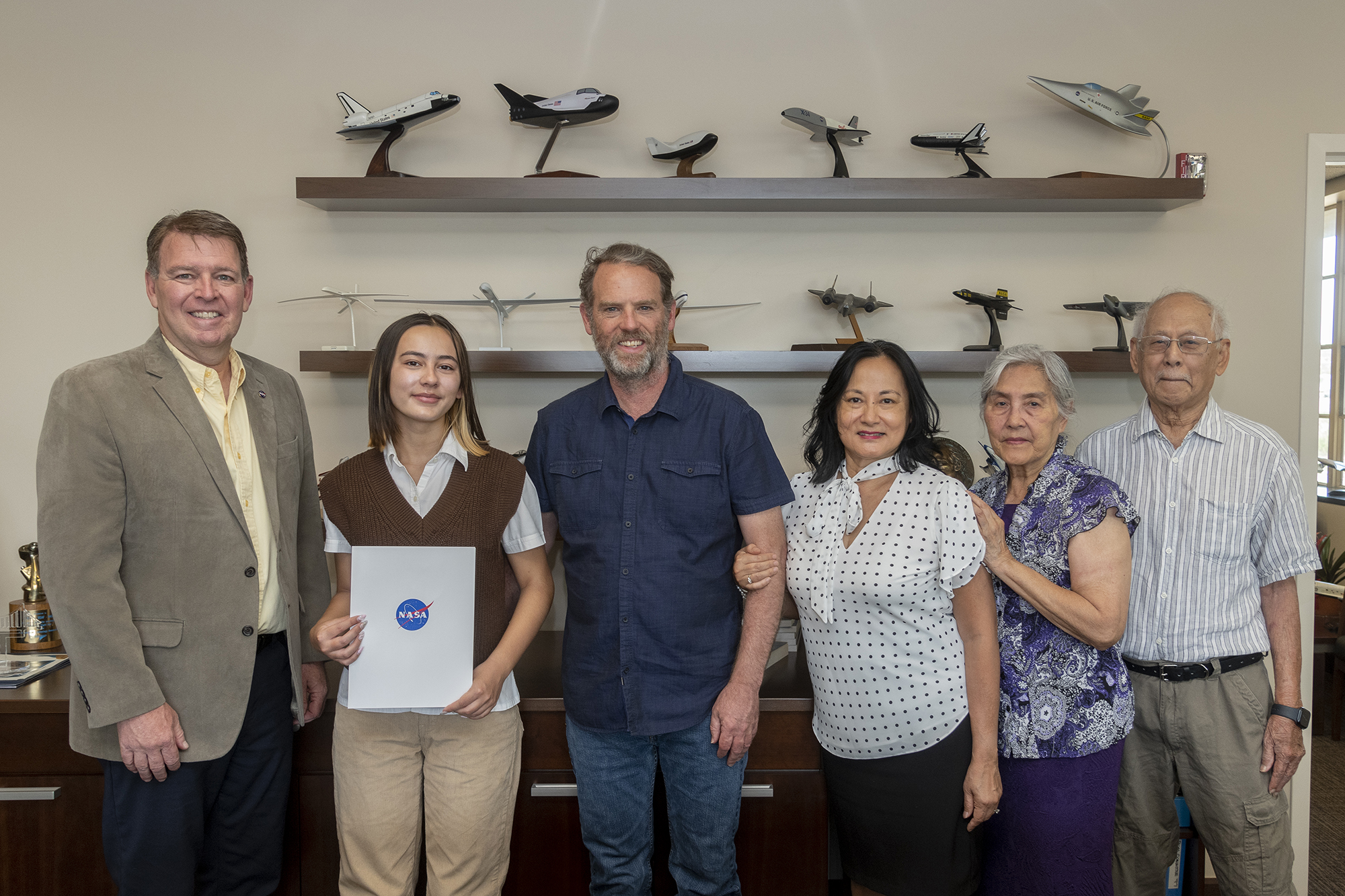 NASA Armstrong Center Director Brad Flick presented Redifer with the 2023 Harold W. Walker Memorial Scholarship Award on July 26. From left are Flick, Redifer, Matt and Saynne Redifer, and Irene and Tim Htut.