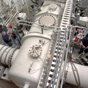 Technicians making adjustments to Vacuum Facility 11 in the Electric Propulsion Research Building.