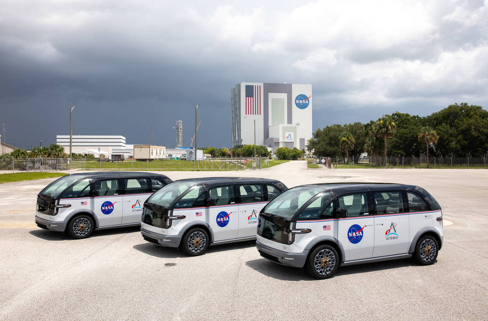 With the Vehicle Assembly Building in the background, three specially designed, fully electric, environmentally friendly crew transportation vehicles for Artemis missions arrived at NASAs Kennedy Space Center in Florida on July 11, 2023.