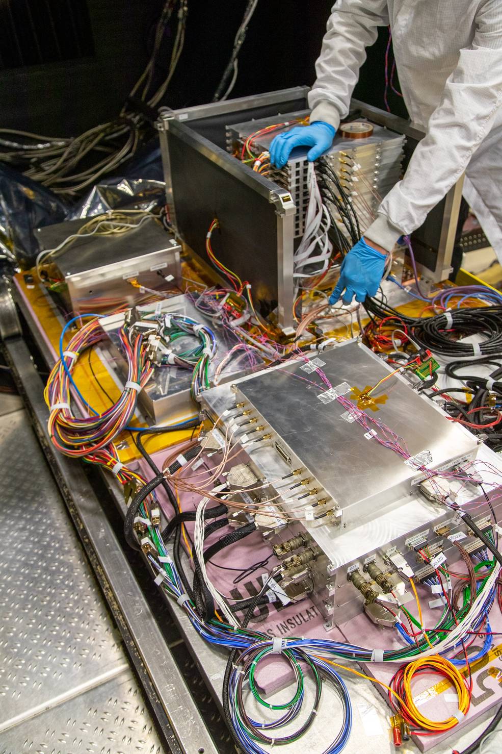 The silver boxes that make up the ComPair instrument are attached by coils of wires.