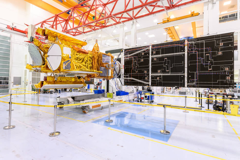 The SWOT satellite sits in a clean room at a Thales Alenia Space facility near Cannes, France, with one of its two solar arrays deployed during testing in January 2022.
