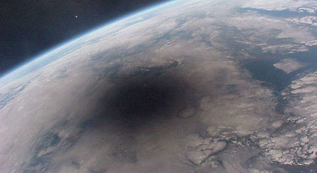The Moon casts a shadow on Earth during a total solar eclipse over Europe in this image taken by a French astronaut on the Mir Space Station
