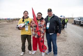 From left, University of Wisconsin, Madison team members Paul Lema, Elias Fox Baker, and team advisor and American Indian Science and Engineering Society Tribal Elder Bret Bennally Thompson are all smiles on their way to launch.