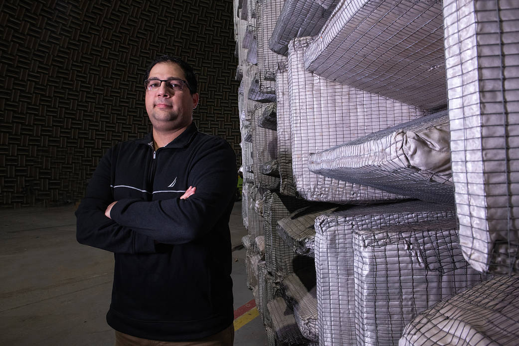 David Avanesian stands inside NASA Glenn’s Aero-Acoustic Propulsion Laboratory.