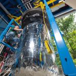 A picture of a worker preparing a 6-foot-tall tank used in CryoFILL experiments to liquefy oxygen at minus 290 degrees Fahrenheit. Testing was conducted at NASA’s Glenn Research Center.