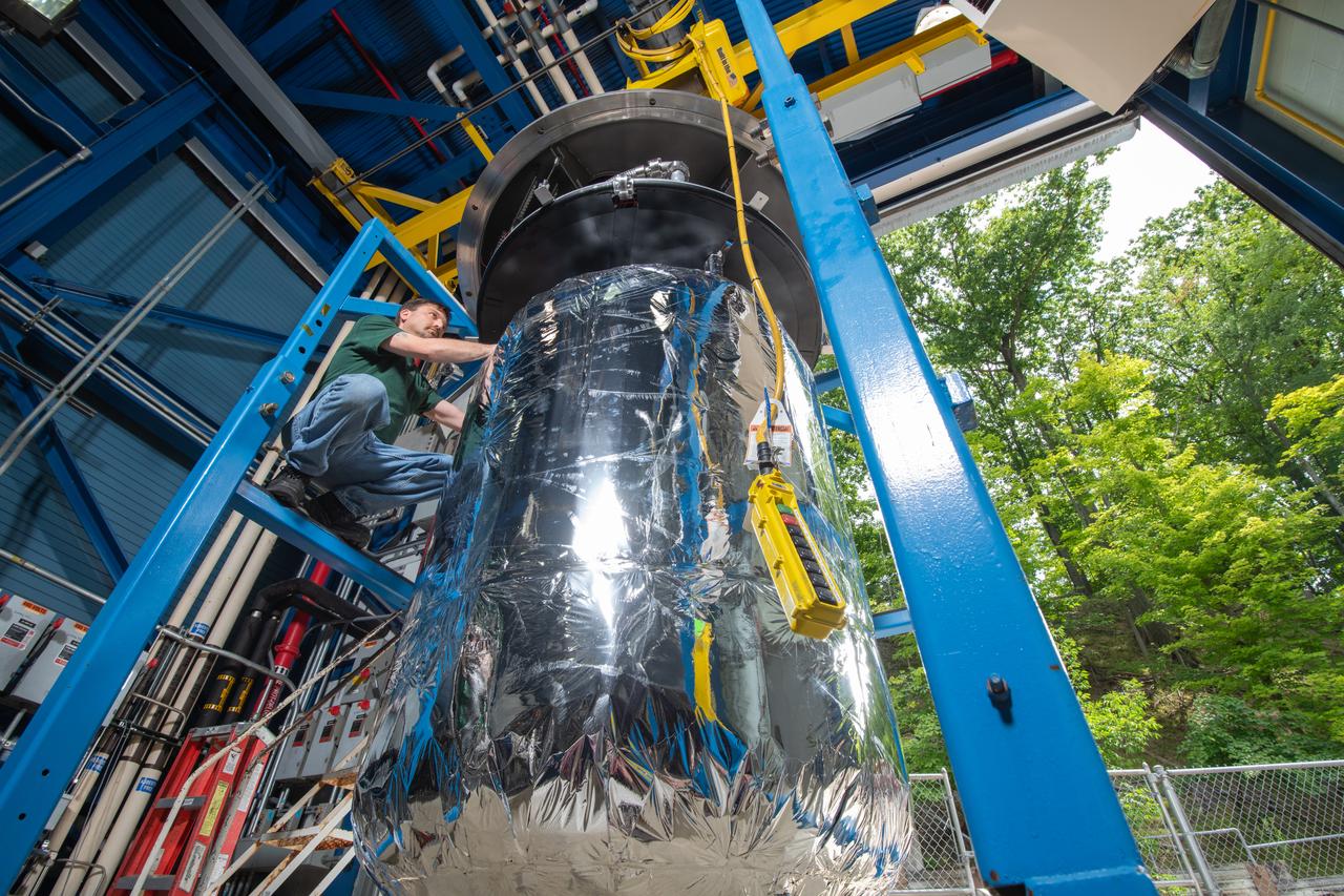 A picture of a worker preparing a 6-foot-tall tank used in CryoFILL experiments to liquefy oxygen at minus 290 degrees Fahrenheit. Testing was conducted at NASAs Glenn Research Center.