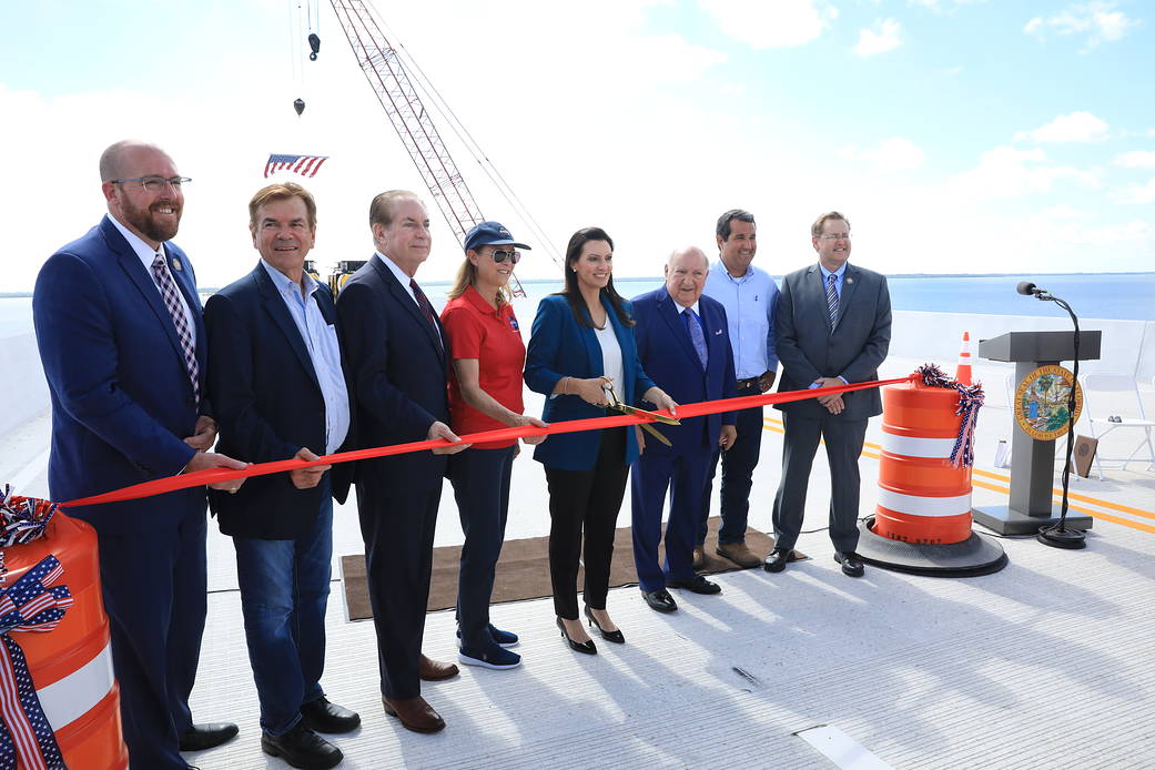 State and local dignitaries, along with Kennedy Space Center Director Janet Petro participate in a ribbon cutting for the opening of the eastbound span of the Indian River Bridge on June 9, 2023.