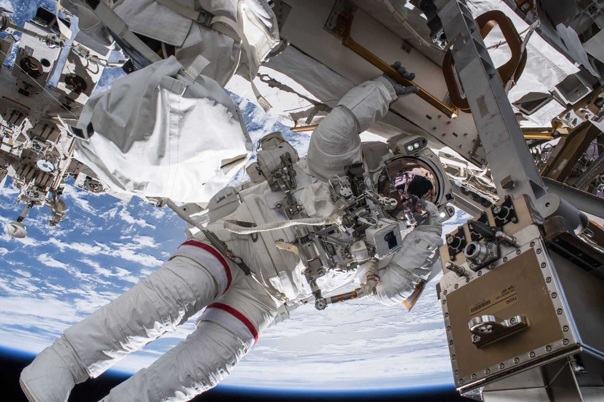 NASA astronaut Drew Feustel seemingly hangs off the International Space Station while conducting a spacewalk.