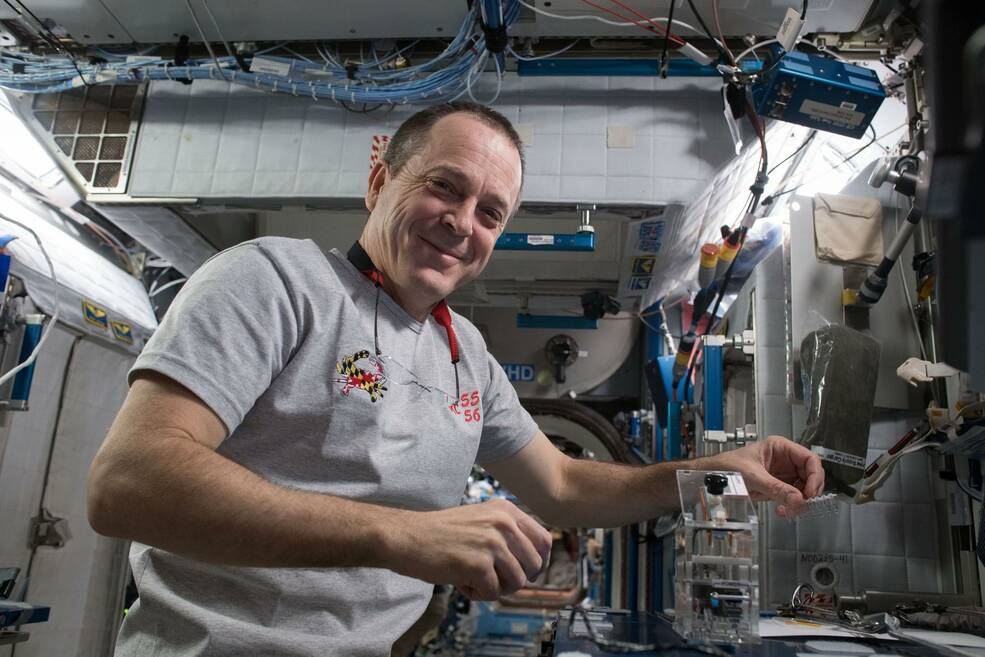 NASA astronaut Ricky Arnold works with the student-designed Genes in Space-5 experiment inside the Harmony module.