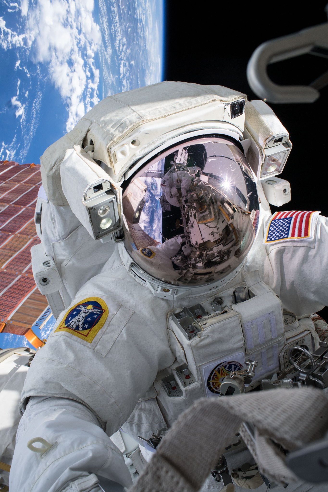 NASA astronaut Andrew Morgan conducts a spacewalk at the Port- 6 (P6) truss structure work site to upgrade International Space Station power systems.
