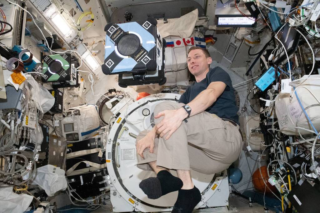 Astronaut Woody Hoburg monitors an Astrobee robotic free-flyer