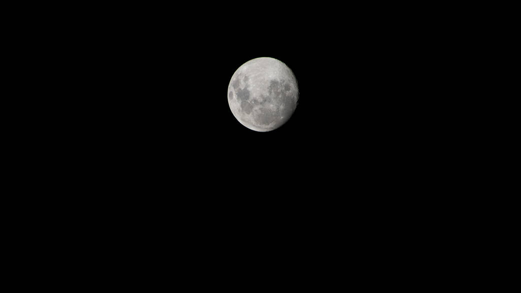 The waxing gibbous Moon is pictured from the International Space Station as it orbited 268 miles above the southern Atlantic Ocean. The Moon is nearly full and it glows brightly against the darkness of space.