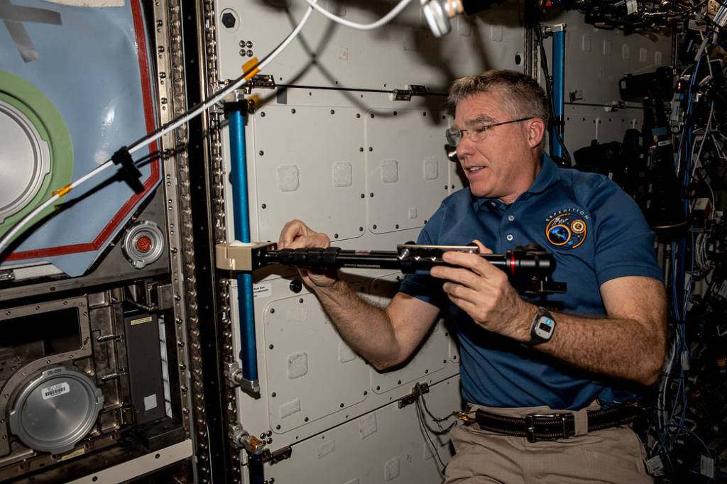 Astronaut Stephen Bowen installs student-made hardware