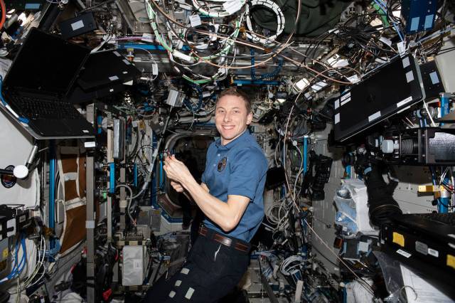 Astronaut Woody Hoburg works on maintenance activities