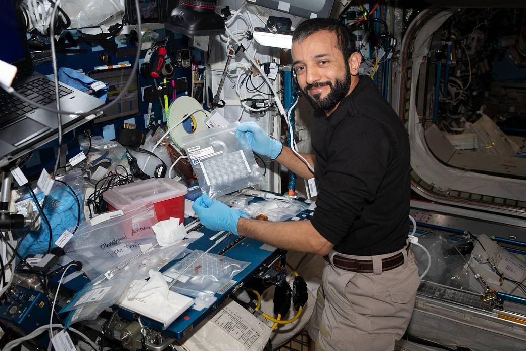 Astronaut Sultan Alneyadi sets up hardware for a protein crystal study