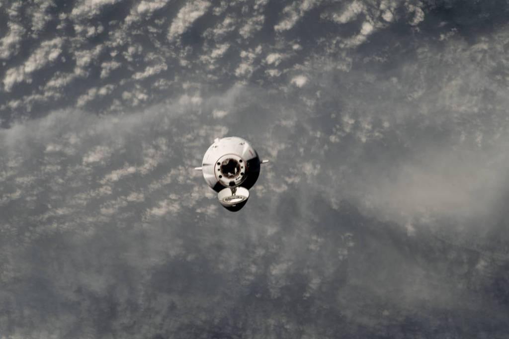 The SpaceX Dragon cargo craft approaches the station for docking