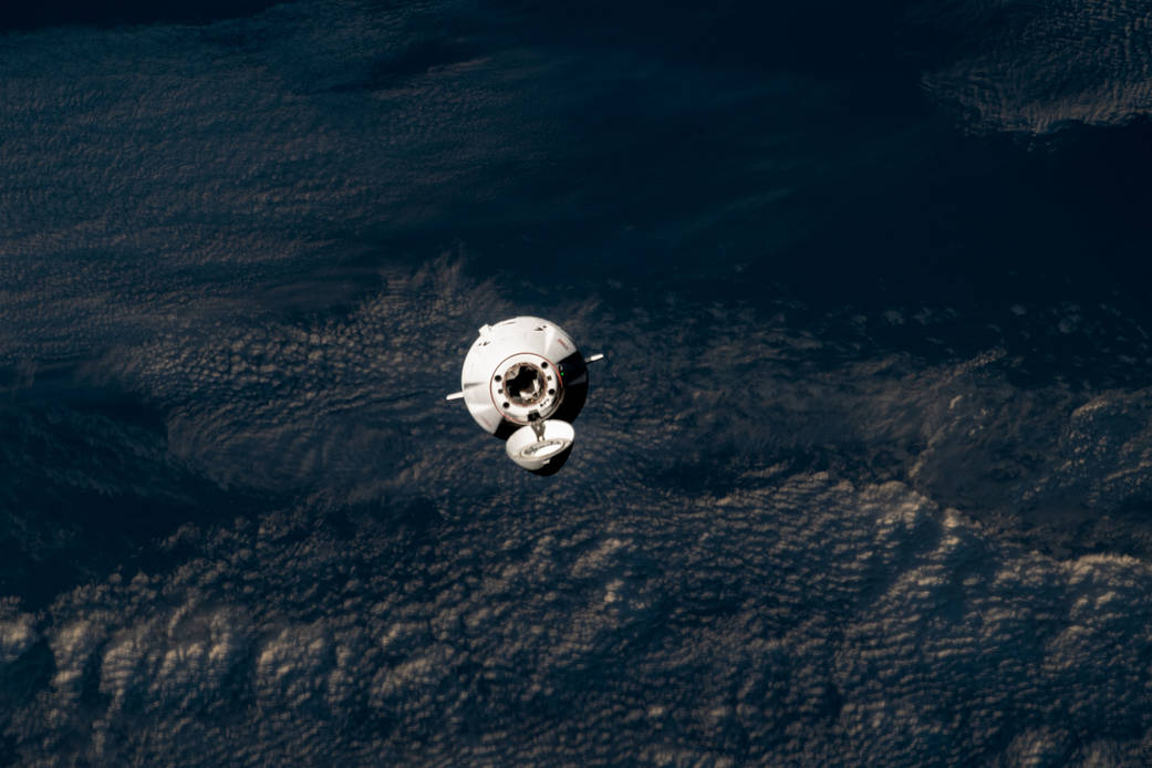 The SpaceX Dragon cargo craft approaches the station for docking