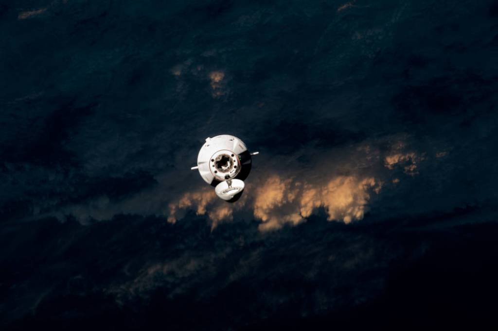 The SpaceX Dragon cargo craft approaches the station for docking
