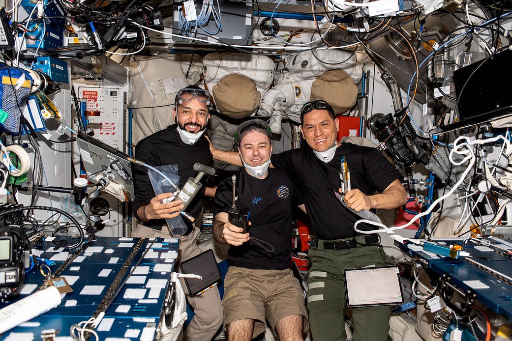 Expedition 69 Flight Engineers pose for a portrait inside the space station