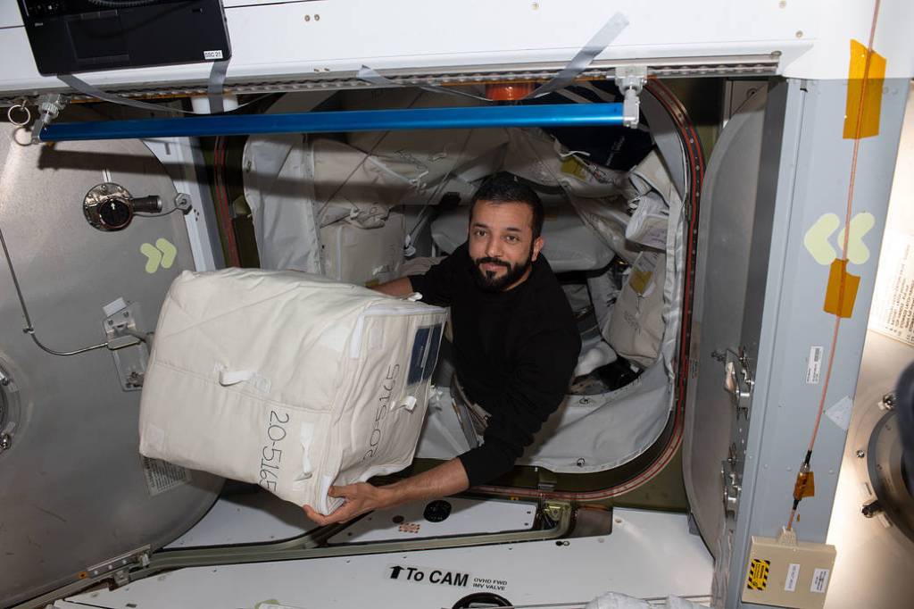 Astronaut Sultan Alneyadi unloads cargo from the Dragon cargo vehicle
