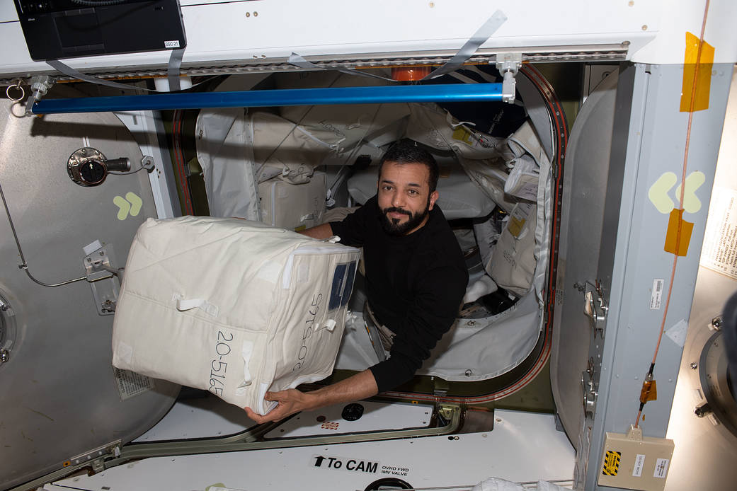 Astronaut Sultan Alneyadi unloads cargo from the Dragon cargo vehicle
