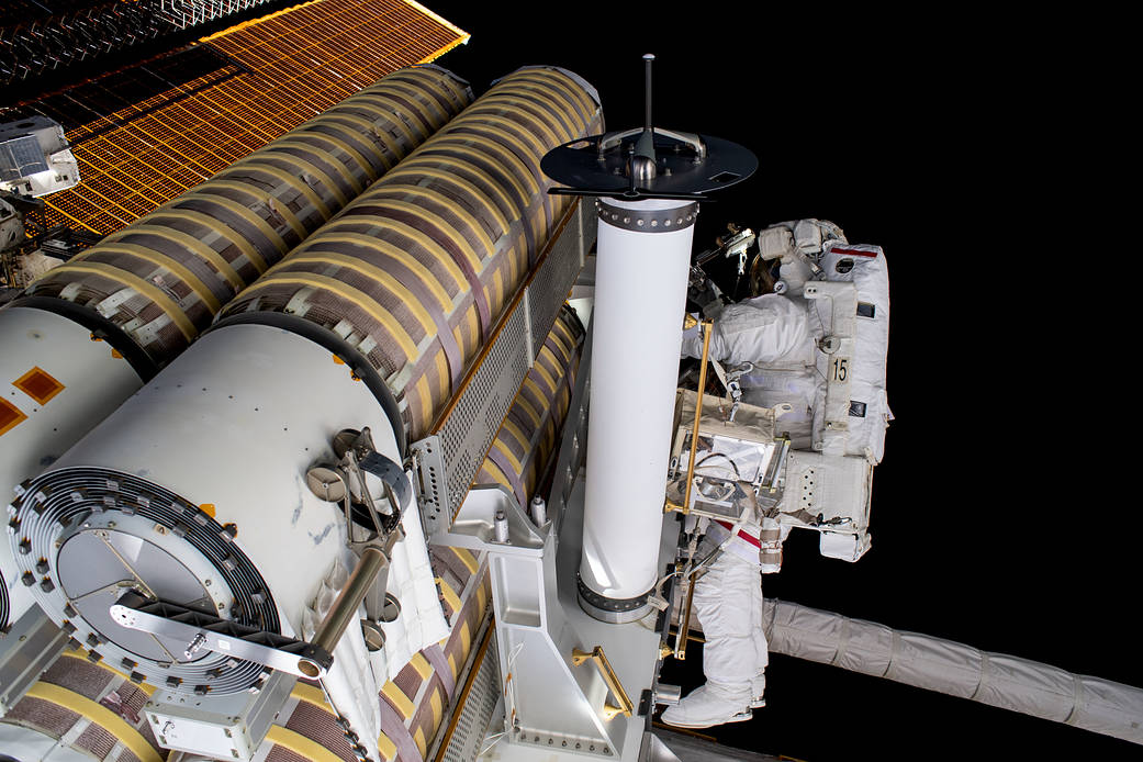 Spacewalker Stephen Bowen works to release a roll-out solar array