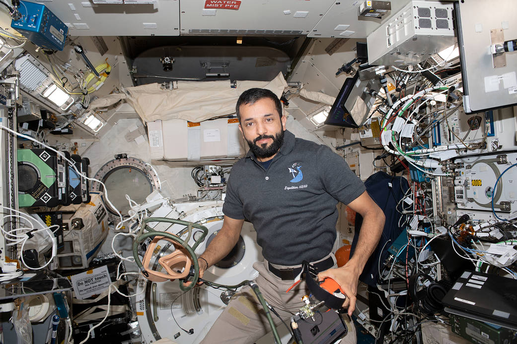 Astronaut Sultan Alneyadi holds portable breathing gear
