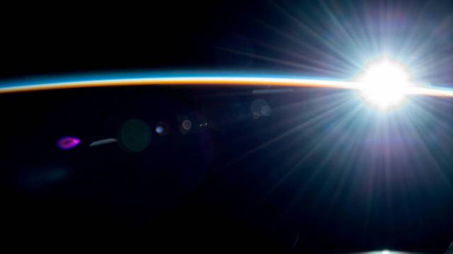 Earth's atmosphere glimmers above the Pacific Ocean