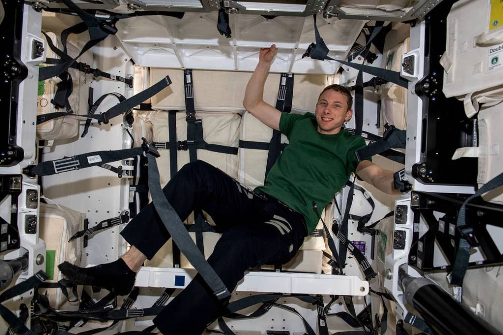 Astronaut Woody Hoburg loads cargo inside the Dragon cargo vehicle