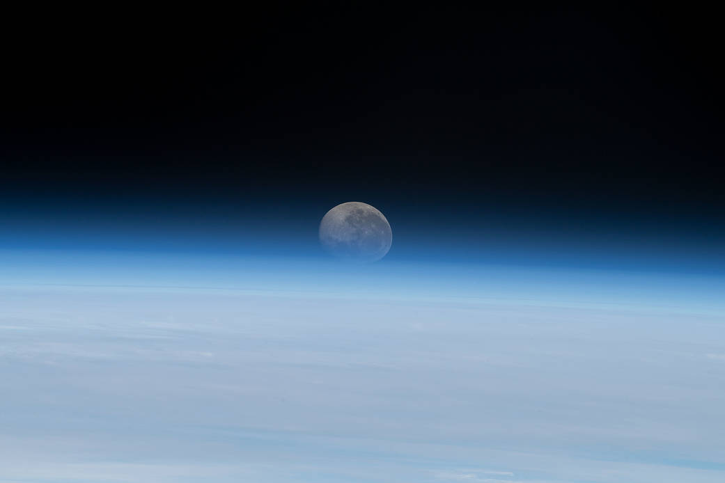The Moon begins setting below Earth's horizon