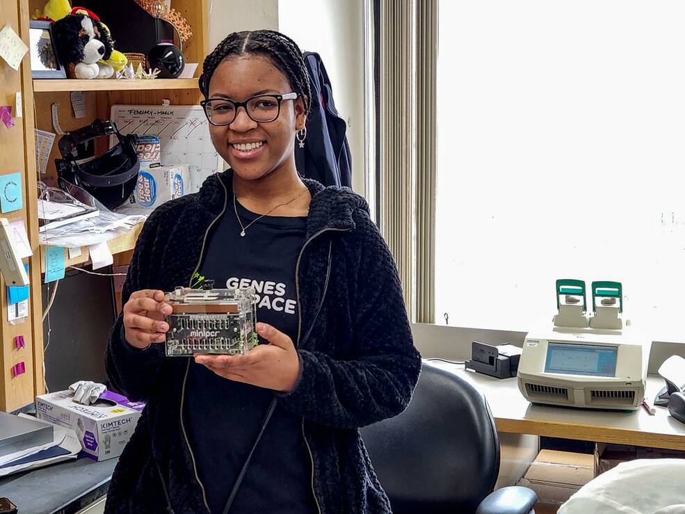 Genes in Space-10 winner, student Pristine Onuoha, holds the miniPCR device, one of the tools astronauts will use to perform her investigation on the International Space Station.