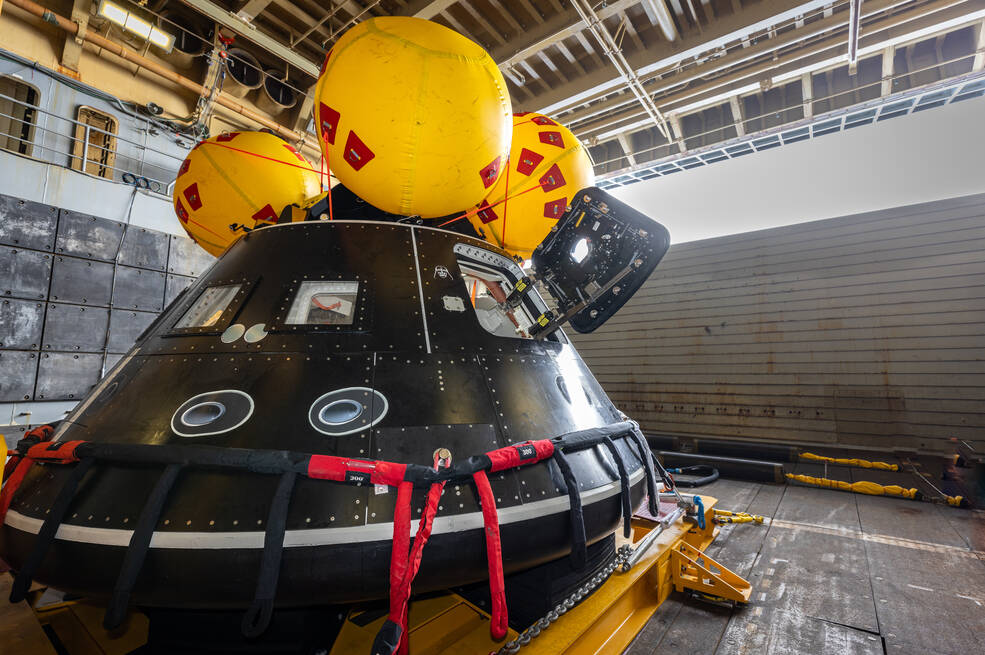 Aboard the USS John P. Murtha, NASA and Department of Defense personnel practice recovery operations for Artemis II in July.