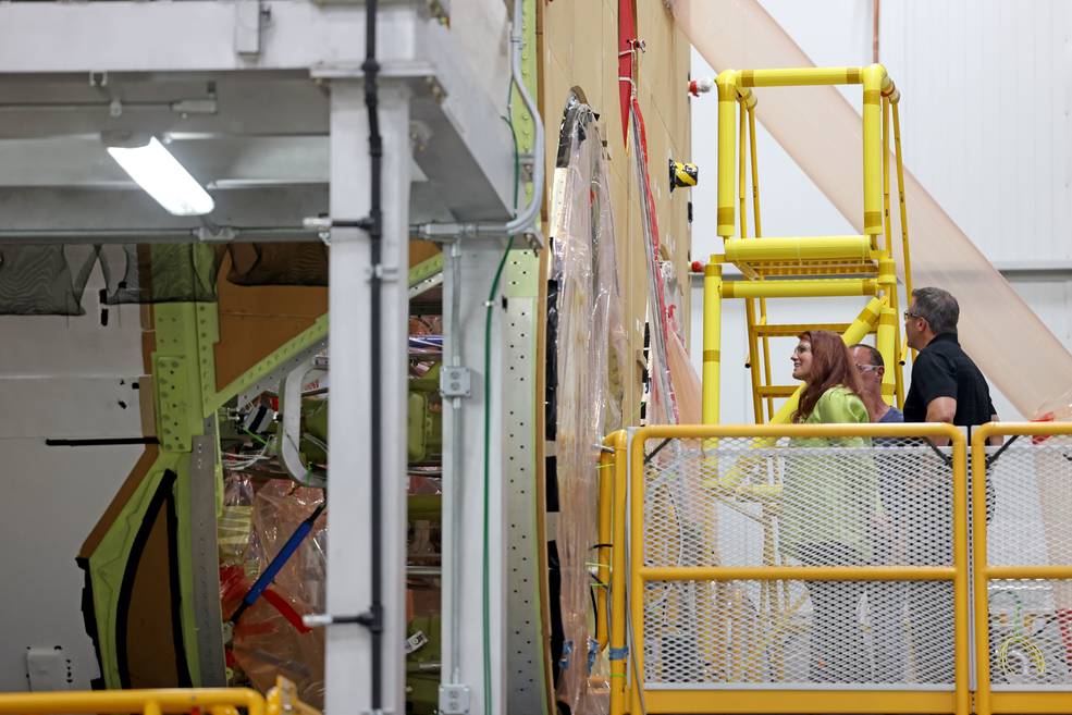 Blackwell-Thompson, left, and Boeings Space Launch System Deputy Program Manager/MAF site lead, Steve Snell, right, view the Artemis II core stage during a tour of the factory.