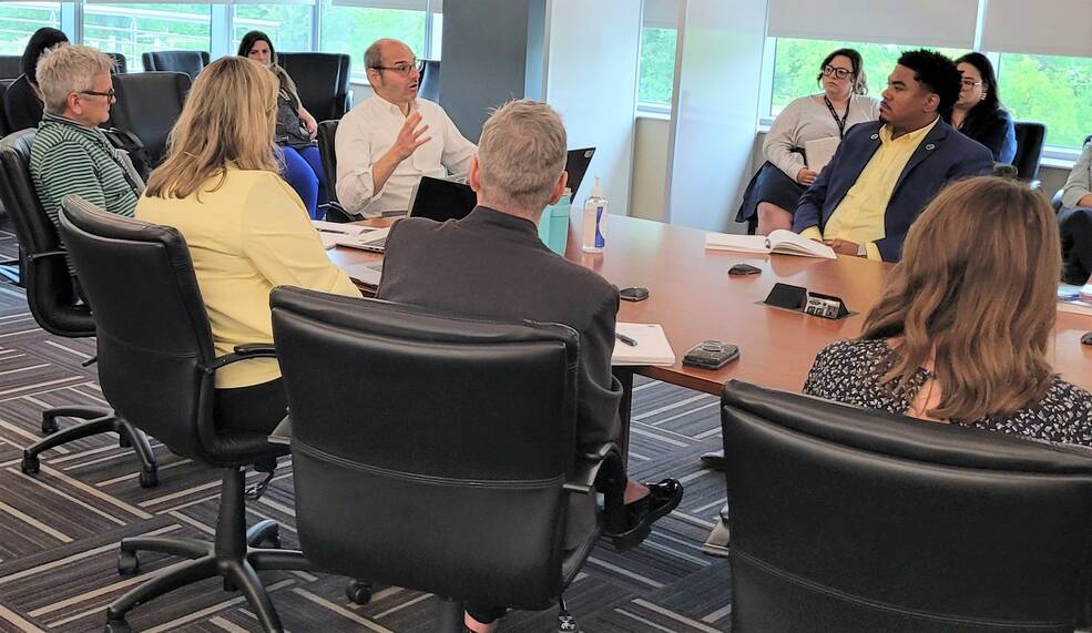 Johnny Stephenson, far left, deputy associate administrator for NASAs Office of Communications (OCOMM), listens, as OCOMM Associate Administrator Marc Etkind, center, talks with NASAs Marshall Space Flight Center OCOMM team members July 19.