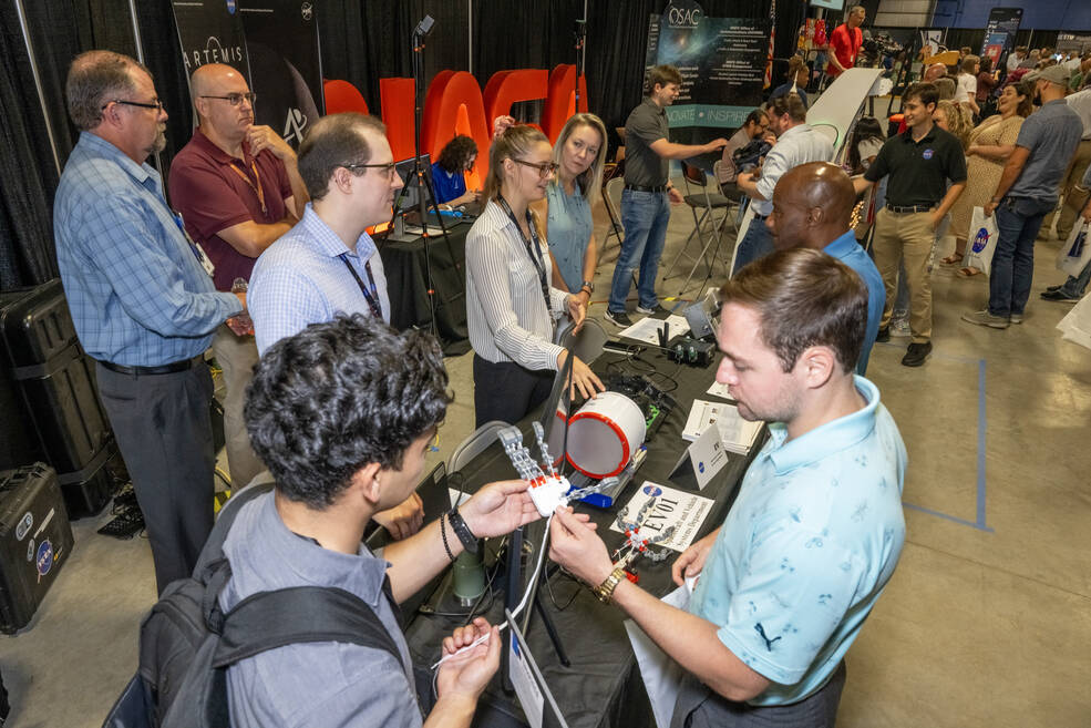 Members of NASA Marshall Space Flight Centers Spacecraft and Vehicle Systems Department (EV) discuss their role in NASAs mission during the Marshall Showcase, held July 24 in Activities Building 4316.