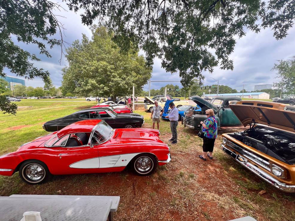 Redstone community members look over some of the cars and trucks on display at the car show.