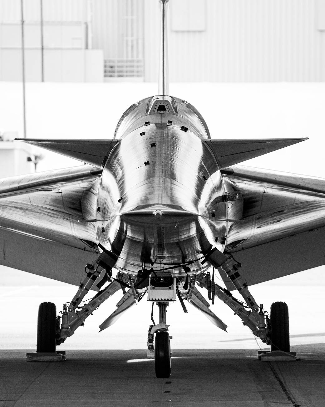 NASA's X-59 parked inside the hangar with a head-on view.
