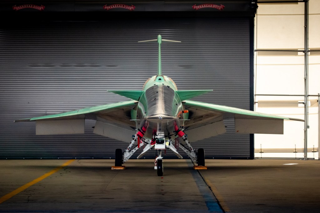 NASA's X-59 parked inside the hangar with a head-on view.