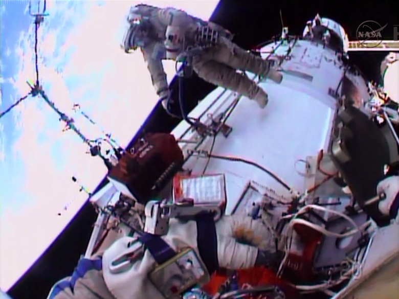 Spacewalker Oleg Kotov works outside the Zvezda service module.