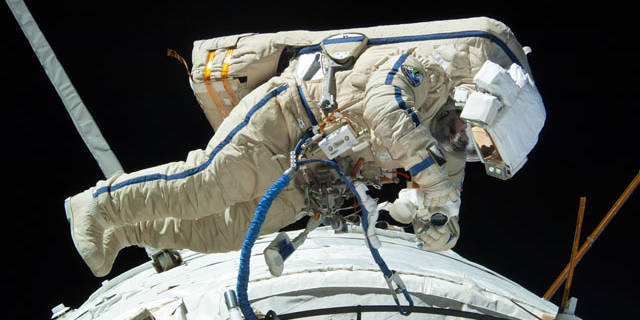 Spacewalker Fyodor Yurchikhin works to complete the replacement of a laser communications experiment with a new platform for a small optical camera system.