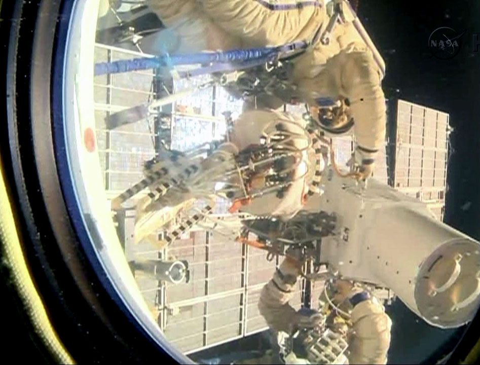 Spacewalkers Oleg Kotov and Sergey Ryazanskiy remove the high resolution camera they installed earlier during Friday's spacewalk.